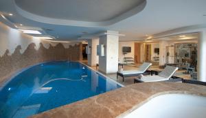 a large swimming pool in a hotel room at Alexandar Montenegro Luxury Suites & Spa in Budva