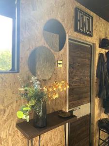 a room with a table with a vase of flowers at Horse Truck Tiny Home in Swords