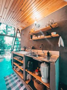 a kitchen with a sink and a counter top at Sítio Aroeira Cabanas in Sao Jorge