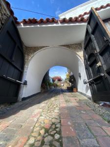 an entrance to a building with an archway at Home Mark Casa Boutique in Paipa