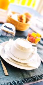a stack of white plates on a table at GîTE MAYO & HYLODES'S SONG in Bouillante