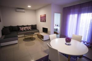 a living room with a couch and a table at Apartments Diva in Ston