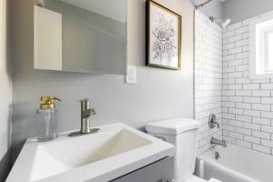 Un baño blanco con lavabo e inodoro. en Westlake Apartment, en Westlake