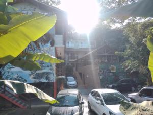 a group of cars parked on a city street at Pousada Naturale in Trindade
