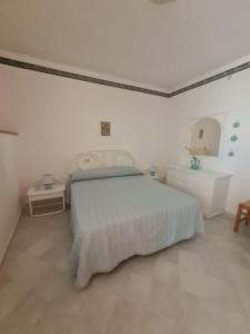 a white bedroom with a bed and a sink at Le Case dei Pescatori - Roseto in Ponza