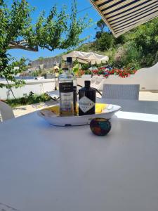 a plate with two bottles of alcohol on a table at Le Case dei Pescatori - Roseto in Ponza