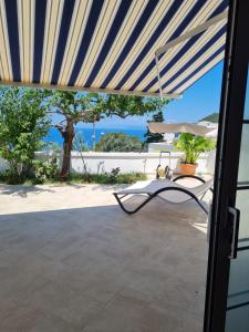 a patio with a table and an umbrella at Le Case dei Pescatori - Roseto in Ponza