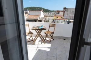 a table and chairs on a balcony with a view at Sapore di Mare al Borgo in Gaeta