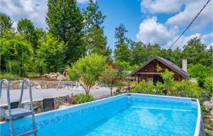 a pool with a chair and a house at Lovely Home In Duga Resa With Outdoor Swimming Pool in Duga Resa