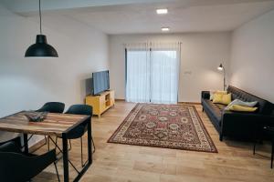 a living room with a couch and a table at feel... Azores - apartments in Velas