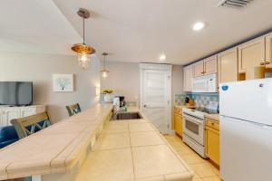 a kitchen with a counter top and a refrigerator at Grand Sandestin #2317 in Destin