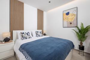 a bedroom with a large bed with a blue blanket at Apartment Salita Calvario in Rijeka
