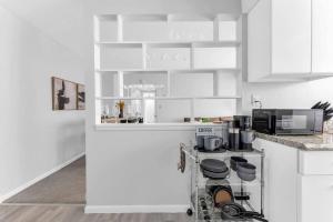 a white kitchen with a stove and a microwave at Maple Heights Getaway in Maple Heights