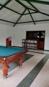 a pool table in the middle of a room at Finca La Esmeralda - mi sitio familiar in La Mesa