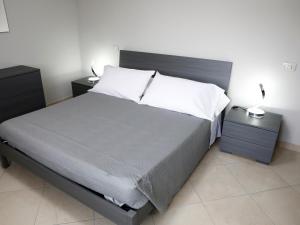 a bedroom with a large bed with two night stands at Villa La Torre in Pagliara +31 photos