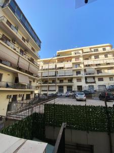 an apartment building with a parking lot in front of it at Little House in Reggio Calabria