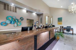 a lobby with a large wooden reception desk at Best Western Redondo Beach Galleria Inn Hotel - Beach City LA in Redondo Beach