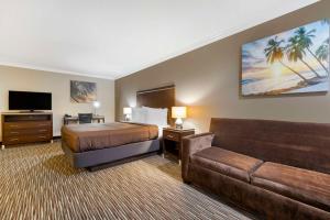 a hotel room with a bed and a couch at Best Western Redondo Beach Galleria Inn Hotel - Beach City LA in Redondo Beach