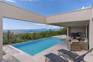 a swimming pool in a house with a view at Villa Ventus in Šmrika