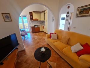 a living room with a couch and a table at Apartments KUĆA SUNCE in Vodnjan