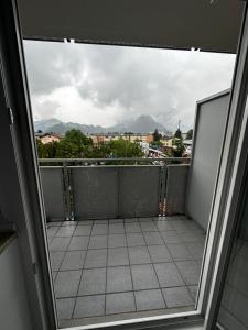 a balcony with a view of a city at City Apartment Nord in Salzburg