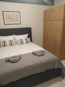 a bedroom with a bed with two stuffed animals on it at CALLI HOUSE in Preveza