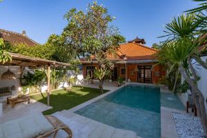 an image of a swimming pool in the backyard of a house at Cozy Up Villa Sanur in Sanur