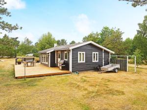 a small house with a deck and a soccer ball at Holiday home Højby III in Højby