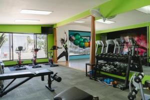 a gym with several treadmills and exercise equipment at Corona Hotel & Spa in Ensenada