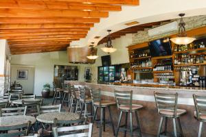 a bar with chairs and tables in a restaurant at Corona Hotel & Spa in Ensenada