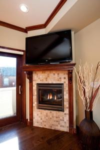 a living room with a fireplace with a tv above it at 270 E College Drive Unit 206 in Durango