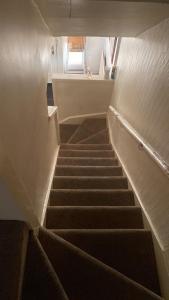 a staircase in a building with a window at Axel room 2 in Manchester