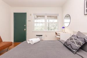 a bedroom with a bed with a green door at Fort Lauderdale Studio - 5 minutes walking to Las Olas Beach in Fort Lauderdale