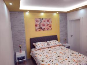a bedroom with a bed and a painting on the wall at Cozy apartment close to Dubrovnik in Neum