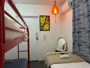 a hospital room with a bunk bed and a mirror at Vieques Good Vibe Guest House in Vieques