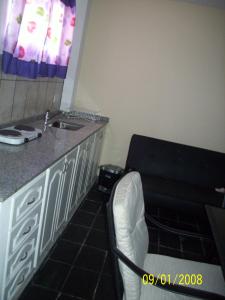 a kitchen with a sink and a chair in a room at Del Fundador in San Luis +12 photos