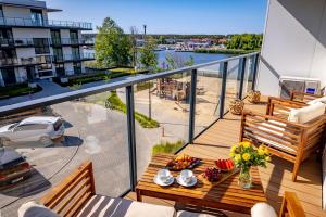 a balcony with a table and chairs on a balcony at Apartament Opal 34 Family & SPA in Dziwnów
