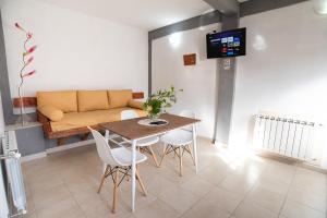 a living room with a table and chairs and a couch at 615 in Ushuaia