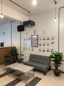 a living room with a couch and a table at Marina Hostel in Ipoh