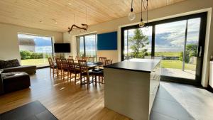 a kitchen and living room with a table and chairs at Pikla Linnumaja in Piirumi