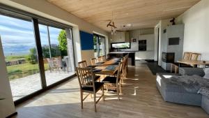 a dining room and living room with a table and chairs at Pikla Linnumaja in Piirumi