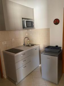 a kitchen with a sink and a microwave at Studio Zubovici 9365a in Zubovići