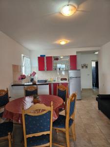a kitchen and dining room with a table and chairs at Apartments by the sea Cove Pjestata, Peljesac - 10210 in Janjina +16 photos