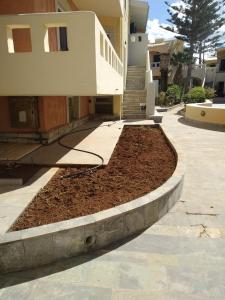 a pile of dirt in front of a house at Niros Beachfront Aparthotel in Kokkíni Khánion