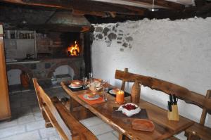 a wooden table in a room with a fireplace at Secluded holiday house Stokic Pod, Velebit - 21524 in Jablanac