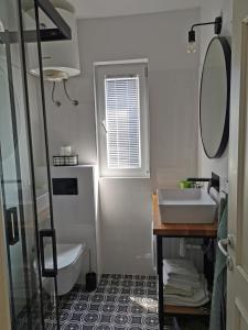 a bathroom with a sink and a mirror at Apartments by the sea Rogoznica - 4805 in Rogoznica
