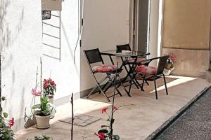 a patio with a table and chairs and some plants at Lovely apartment Morje - Koper old town in Koper