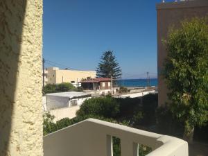 a view of the ocean from a building at Niros Beachfront Aparthotel in Kokkíni Khánion