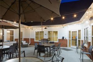 a patio with tables and chairs and an umbrella at Residence Inn Manassas Battlefield Park in Manassas