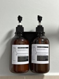two bottles of soap sitting next to each other at Be Right Back Loft - Bukit Mertajam in Bukit Mertajam